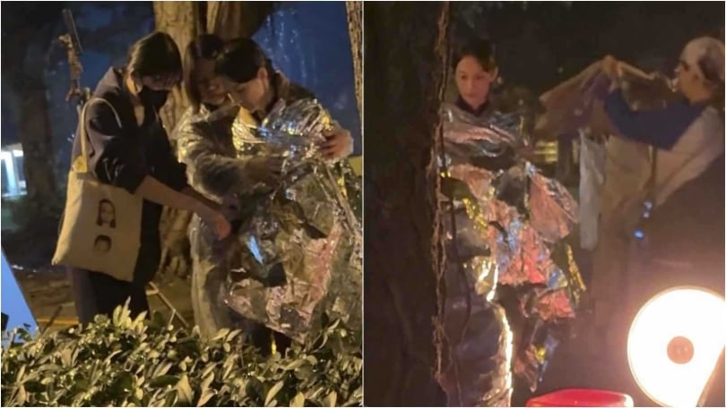 工作人員趕緊幫凍僵的簡嫚書保暖，細看帆布袋上疑似印著簡嫚書兩個女兒的臉。（圖／讀者提供）